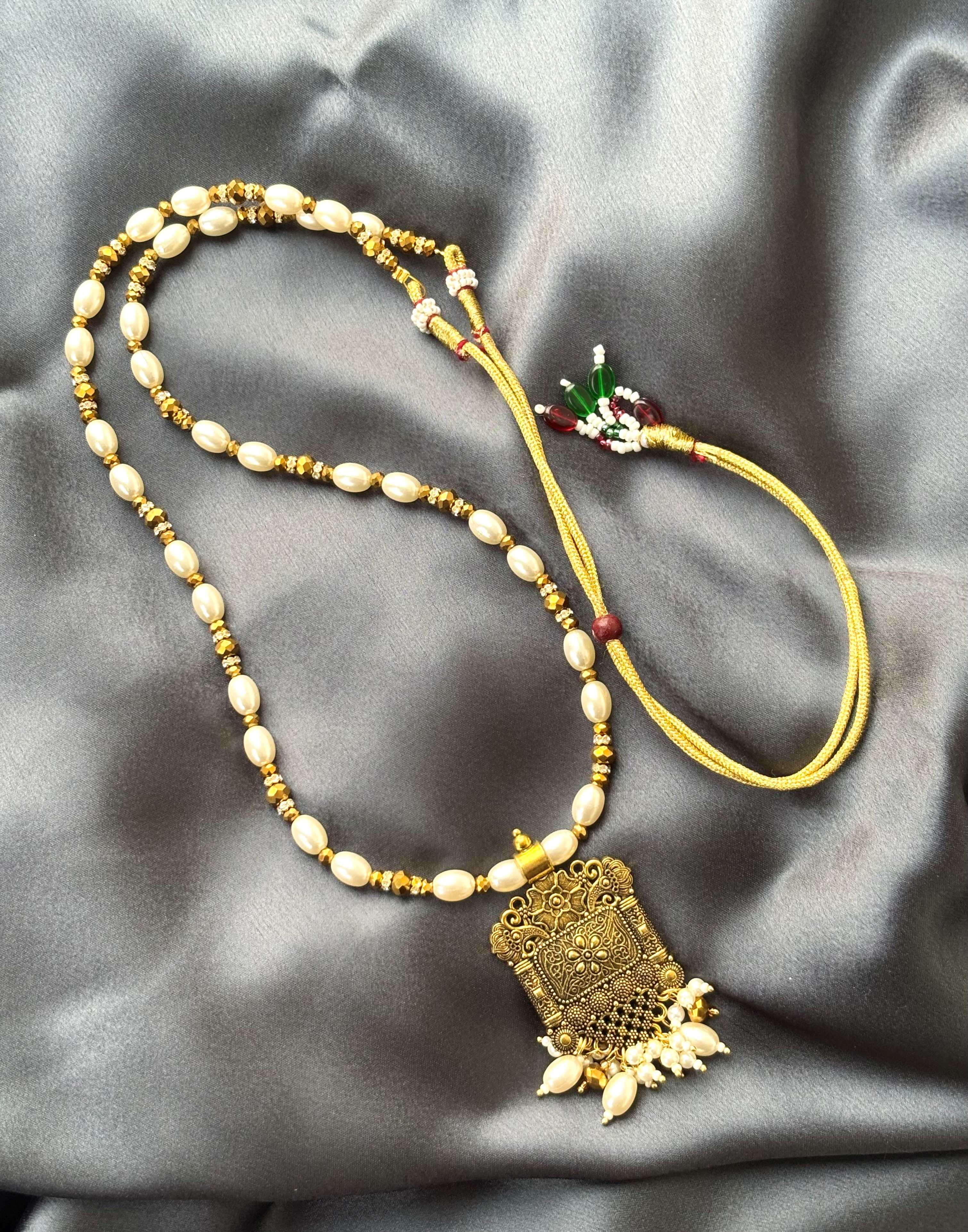 Gold Pendant and Rice Pearl Necklace