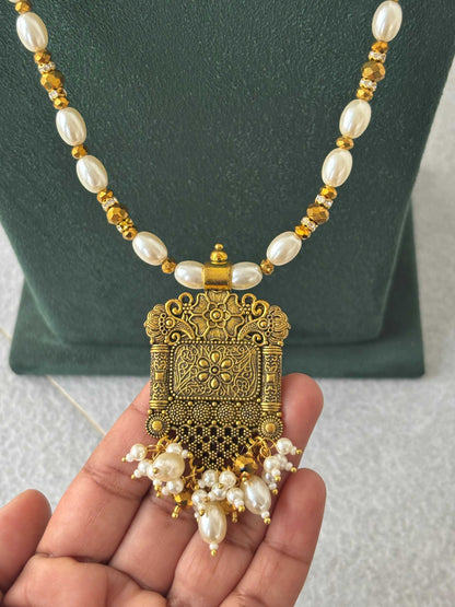 Gold Pendant and Rice Pearl Necklace