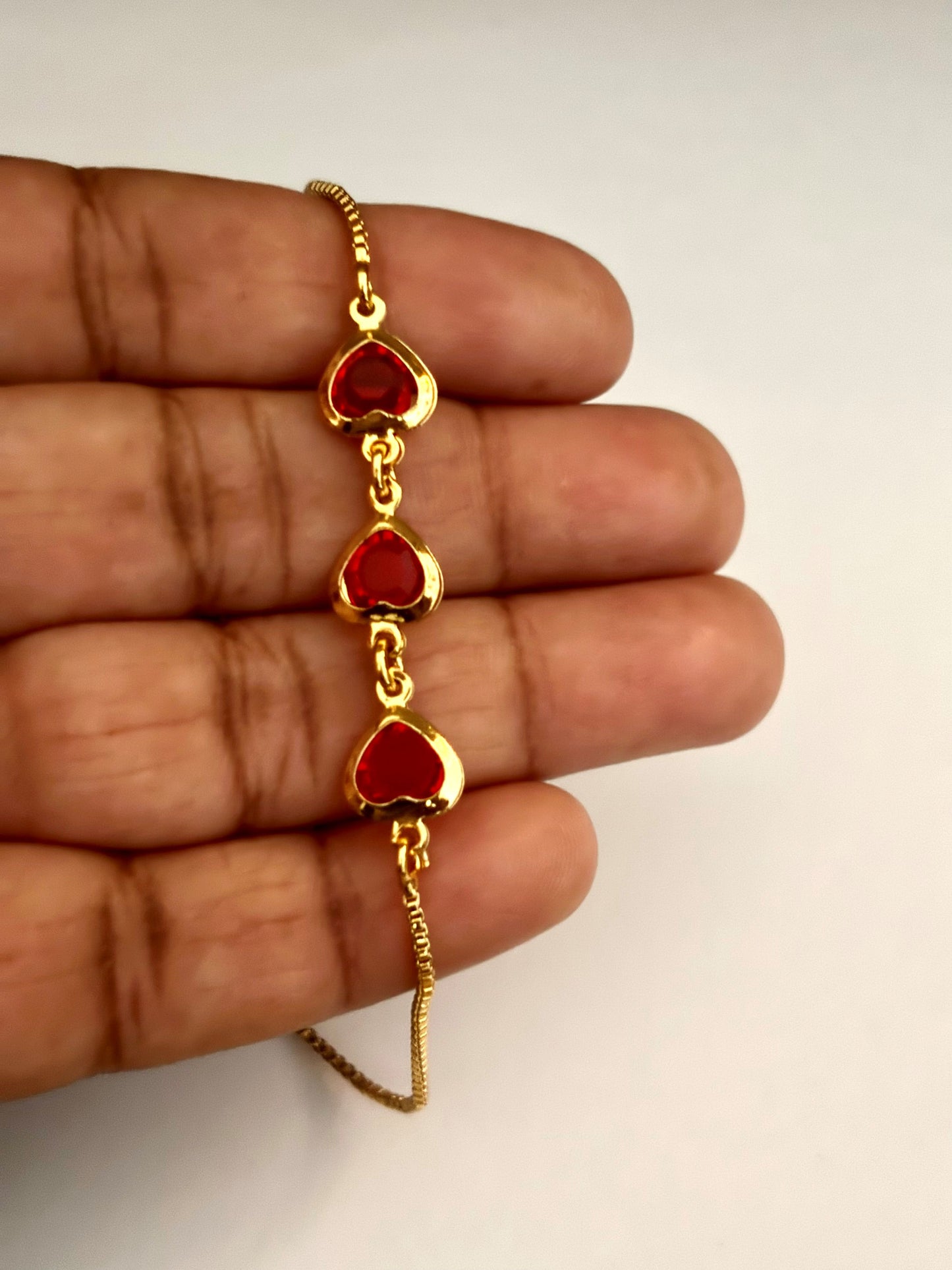 Gold-Plated Bracelet with Three Red Heart Stones